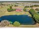 Panoramic aerial shot of a golf course, lake, and clubhouse in a picturesque community at 7078 Lexington Cir, Brooksville, FL 34602