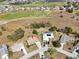 Aerial shot of the house with large lawn and view of the nearby community and golf course at 7078 Lexington Cir, Brooksville, FL 34602