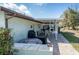 Outdoor patio with a covered area, table, chairs, and view of yard at 7078 Lexington Cir, Brooksville, FL 34602