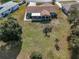 Aerial view of a home's backyard, complete with a patio and screened-in porch at 7078 Lexington Cir, Brooksville, FL 34602