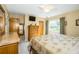 Comfortable bedroom with a large bed, dresser, ceiling fan, and natural light from the window at 7078 Lexington Cir, Brooksville, FL 34602