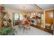 Bright dining room with sliding glass doors to the screened lanai and adjacent eat-in kitchen at 7078 Lexington Cir, Brooksville, FL 34602