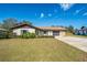 Charming single-story home with a well-manicured lawn and an attached two-car garage at 7078 Lexington Cir, Brooksville, FL 34602