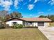 Charming single-story home with a well-manicured lawn and an attached two-car garage at 7078 Lexington Cir, Brooksville, FL 34602