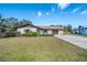 Charming single-story home with a well-manicured lawn and an attached two-car garage at 7078 Lexington Cir, Brooksville, FL 34602