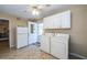 Functional laundry room with washer, dryer, cabinets, access to a screen patio, and natural light at 7078 Lexington Cir, Brooksville, FL 34602