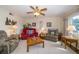 Cozy living room with comfortable seating, hardwood floors, and a ceiling fan at 7078 Lexington Cir, Brooksville, FL 34602