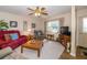 Comfortable living room with ample seating, a ceiling fan, and a large window at 7078 Lexington Cir, Brooksville, FL 34602