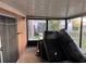 View of an enclosed patio featuring an old couch, screens, and sliding glass doors that opens up to the backyard at 8428 Paxton Dr, Port Richey, FL 34668