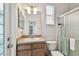 Cozy bathroom with shower, toilet, and sink with mirror and cabinet storage at 1001 Bayvista Dr, Tarpon Springs, FL 34689