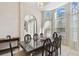 Well-lit dining room with a large table, seating for eight, and arched windows at 1001 Bayvista Dr, Tarpon Springs, FL 34689