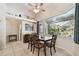 Bright dining room features a large window overlooking the pool and stylish furnishings at 1001 Bayvista Dr, Tarpon Springs, FL 34689