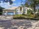 Charming home with a three-car garage and lush landscaping at 1001 Bayvista Dr, Tarpon Springs, FL 34689