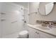 Well-lit bathroom featuring a stand-up shower with grab bars and a sleek vanity with decorative backsplash at 11248 Andy Dr, Riverview, FL 33569