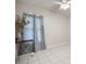 Bedroom with light tile flooring, contemporary gray curtains, and soft natural light at 11248 Andy Dr, Riverview, FL 33569