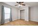 This bedroom features laminate flooring, a ceiling fan, natural light and a closet with bi-fold doors at 11248 Andy Dr, Riverview, FL 33569