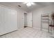 This bedroom features tile flooring, a ceiling fan, natural light and a closet with bi-fold doors at 11248 Andy Dr, Riverview, FL 33569