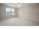 Bright, airy bedroom with a large window and neutral tile flooring at 11248 Andy Dr, Riverview, FL 33569