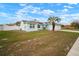 Charming light blue home featuring a well-manicured lawn and a two-car garage at 11248 Andy Dr, Riverview, FL 33569