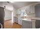 Bright eat-in kitchen featuring stainless steel appliances, gray cabinets, granite countertops, and wood-look flooring at 11248 Andy Dr, Riverview, FL 33569