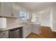 Kitchen featuring stainless steel dishwasher, gray cabinets and granite countertop at 11248 Andy Dr, Riverview, FL 33569