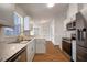 Bright kitchen with stainless steel appliances, light gray cabinets, and granite countertops at 11248 Andy Dr, Riverview, FL 33569