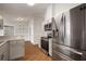 Kitchen featuring stainless steel appliances, light gray cabinets, and granite countertops at 11248 Andy Dr, Riverview, FL 33569