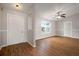 Bright living room featuring wood floors, large window, and paneled walls at 11248 Andy Dr, Riverview, FL 33569