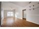 Bright living room with wood floors, ceiling fan, and stylish shelving at 11248 Andy Dr, Riverview, FL 33569