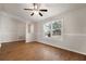 Bright living room with wood floors, arched window, and neutral wall color at 11248 Andy Dr, Riverview, FL 33569