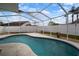 Screened-in pool area with a kidney-shaped pool and white fencing at 11248 Andy Dr, Riverview, FL 33569