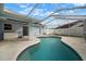 Covered pool patio featuring a kidney-shaped pool and exterior access at 11248 Andy Dr, Riverview, FL 33569