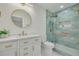 Modern bathroom with a stylish vanity, gold finishes, and luxurious glass shower at 121 Shirley Dr, Largo, FL 33770