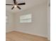 Empty bedroom with hardwood floors and a ceiling fan with natural light at 121 Shirley Dr, Largo, FL 33770