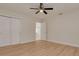 Bedroom with ceiling fan, wood floors, closet, and white trim, featuring modern design at 121 Shirley Dr, Largo, FL 33770