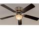 Image of ceiling fan with dark wooden blades against white ceiling with light fixture at 121 Shirley Dr, Largo, FL 33770