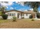 Charming single-story home featuring a well-manicured front yard and a classic brick and siding exterior at 121 Shirley Dr, Largo, FL 33770