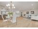 Bright and airy living room with a dining area featuring modern decor, sleek flooring, and an open layout at 121 Shirley Dr, Largo, FL 33770