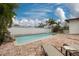 Backyard pool with brick patio, waterfall feature, and manicured landscaping, creating a private oasis at 121 Shirley Dr, Largo, FL 33770