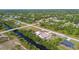 Scenic aerial of a home near a waterway, surrounded by lush trees in a peaceful neighborhood at 12769 Foresman Blvd, Port Charlotte, FL 33981