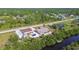 Aerial view of a house with a separate garage building, and a serene waterfront with private dock at 12769 Foresman Blvd, Port Charlotte, FL 33981