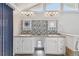 Bright bathroom with double vanity sinks and white cabinets at 12769 Foresman Blvd, Port Charlotte, FL 33981