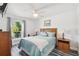 Cozy bedroom with a ceiling fan and a large window offering natural light at 12769 Foresman Blvd, Port Charlotte, FL 33981