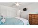 Bedroom featuring a ceiling fan, dresser, and closet at 12769 Foresman Blvd, Port Charlotte, FL 33981