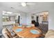 The dining room connects to the open kitchen and living room and is fitted with a ceiling fan at 12769 Foresman Blvd, Port Charlotte, FL 33981