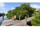 Cozy dock view with a relaxing chair, offering tranquil waterfront enjoyment surrounded by lush mangroves at 12769 Foresman Blvd, Port Charlotte, FL 33981