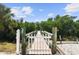 Charming dock entrance featuring whimsical decorations leading to a serene waterfront retreat at 12769 Foresman Blvd, Port Charlotte, FL 33981