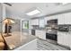 This kitchen features granite countertops, stainless steel appliances, and an open floor plan at 12769 Foresman Blvd, Port Charlotte, FL 33981