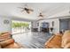 Living room features vaulted ceilings, luxury vinyl plank flooring, and sliding glass doors to the lanai at 12769 Foresman Blvd, Port Charlotte, FL 33981