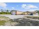 Exterior view of a large outbuilding, detached garage and partial home view at 12769 Foresman Blvd, Port Charlotte, FL 33981